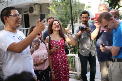 People react as US Pastor Andrew Craig Brunson (unseen) arrives at his house on July 25, 2018 in Izmir.  Turkey on July 15, 2018 moved from jail to house arrest US pastor Andrew Brunson who has spent almost two years imprisoned on terror-related charges, in a controversial case that has ratcheted up tensions with the United States. Andrew Brunson, who ran a protestant church in the Aegean city of Izmir, was first detained in October 2016 and had remained in prison in Turkey ever since. 
  / AFP / -
