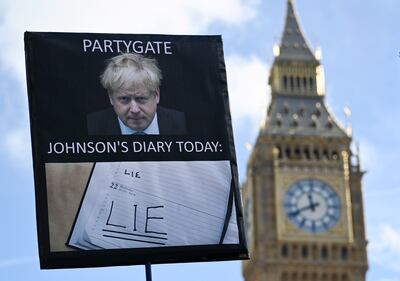 A protester's sign against Boris Johnson outside Parliament. EPA 