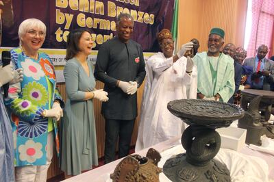 German Foreign Minister Annalena Baerbock, second left, Nigerian Foreign Minister Geoffrey Onyeama, third left, and Nigerian Culture Minister Lai Mohammed, fourth left, and other officials, in Abuja. AP