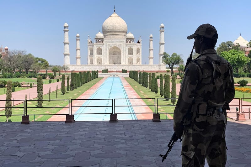 FILE PHOTO: A member of Central Industrial Security Force (CISF) personnel stands guard inside the empty premises of the historic Taj Mahal during a 21-day nationwide lockdown to slow the spread of COVID-19, in Agra, India, April 2, 2020. REUTERS/Sunil Kataria/File Photo