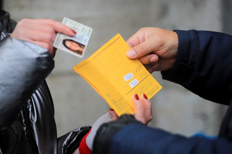 A security guard checks a vaccination pass in Cologne, Germany. Reuters