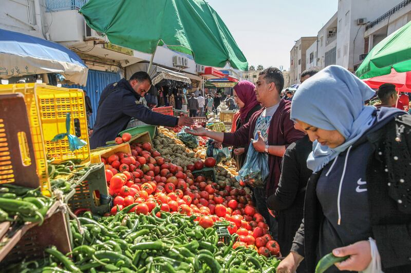 Customers shop for fresh produce at a street market in the Ariana district of Tunis. Bloomberg