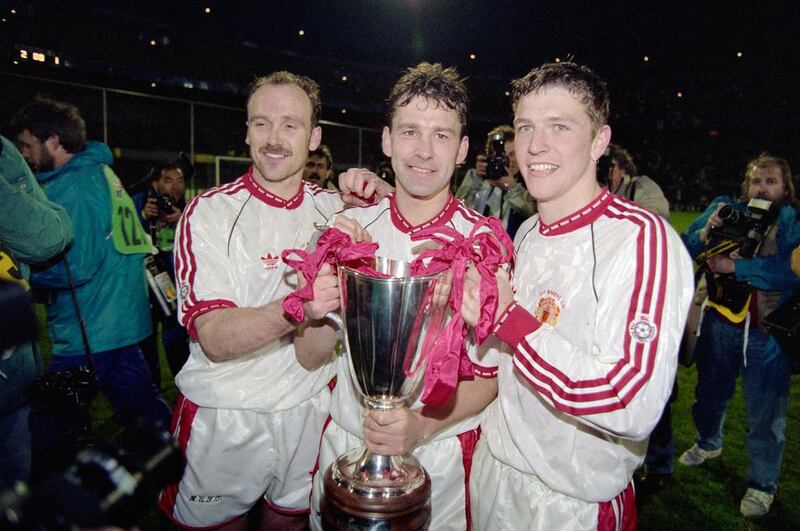 From left: Manchester United players Mike Phelan, captain Bryan Robson and Lee Sharpe celebrate with the European Cup Winners' Cup trophy after a 2-1 victory over Spanish club Barcelona in Rotterdam, Netherlands, on May 15, 1991. Simon Bruty / Getty Images