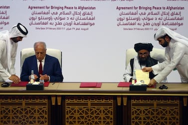 Mullah Abdul Ghani Baradar, the leader of the Taliban delegation, signs an agreement with Zalmay Khalilzad, U.S. envoy for peace in Afghanistan, at a signing agreement ceremony between members of Afghanistan's Taliban and the U.S. in Doha, Qatar February 29, 2020. REUTERS/Ibraheem al Omari