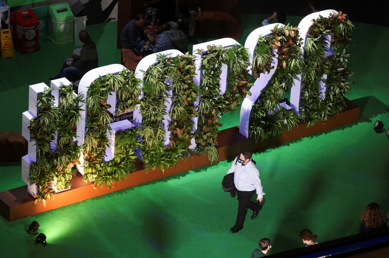 A delegate walks past Cop26 branding at the venue. Reuters