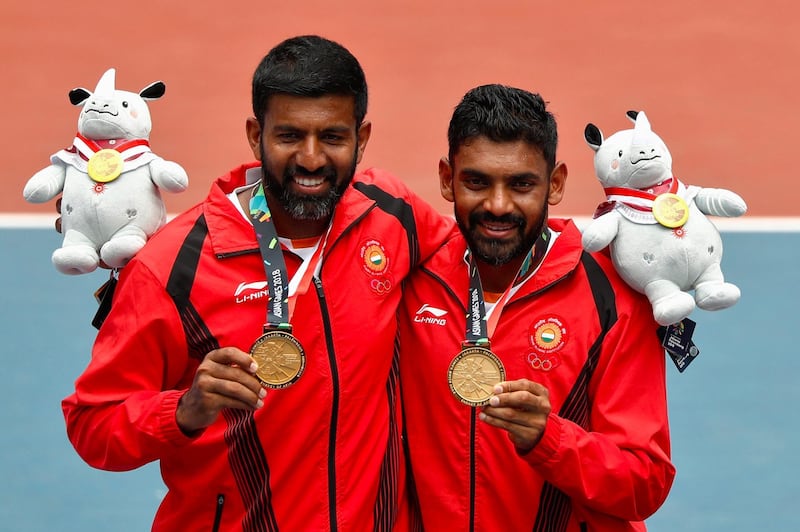 Gold medallists Rohan Bopanna, left, and Divij Sharan of India celebrate their men's doubles tennis win. Edgar Su / Reuters