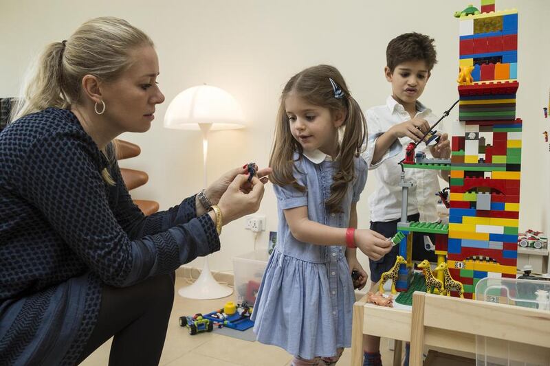 Kristina Kunz Kharazmi collects Lego and Duplo blocks for underpriviliged children in the Philipines. She is pictured here with her son Alexander and daughter Izabella. Antonie Robertson / The National
