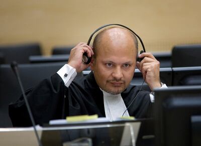 FILE  - In this Monday, June 4, 2007 file photo, lawyer Karim Khan adjust his headphones in the courtroom of the Special Court for Sierra Leone in The Hague, the Netherlands.  Khan is being sworn in Wednesday, June 16, 2021 as the new chief prosecutor of the International Criminal Court, taking leadership of a busy and financially stretched team that is probing alleged atrocities around the globe. Khan, a 51-year-old English lawyer, has years of experience in international lawyer as a prosecutor, investigator and defense attorney. He takes over from Fatou Bensouda of Gambia, whose nine-year term ended Tuesday. (AP Photo/Robert Vos, Pool, File)