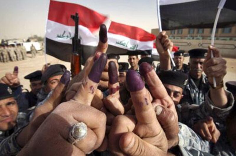 "Iraqi security forces took the lead" as Iraqis went to the polls: police in Najaf raise their inked fingers after voting.