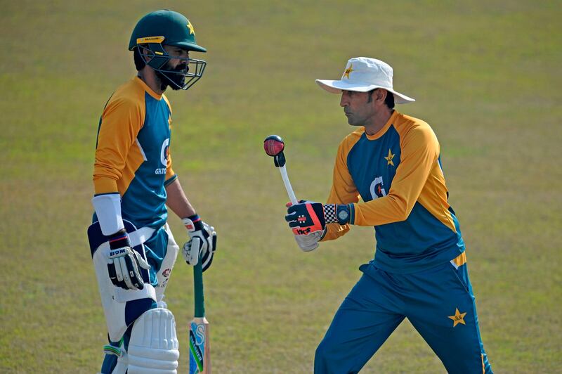 Pakistan's batting coach Younis Khan gives tips to Fawad Alam during a practice session at the Rawalpindi Cricket Stadium on Monday. AFP