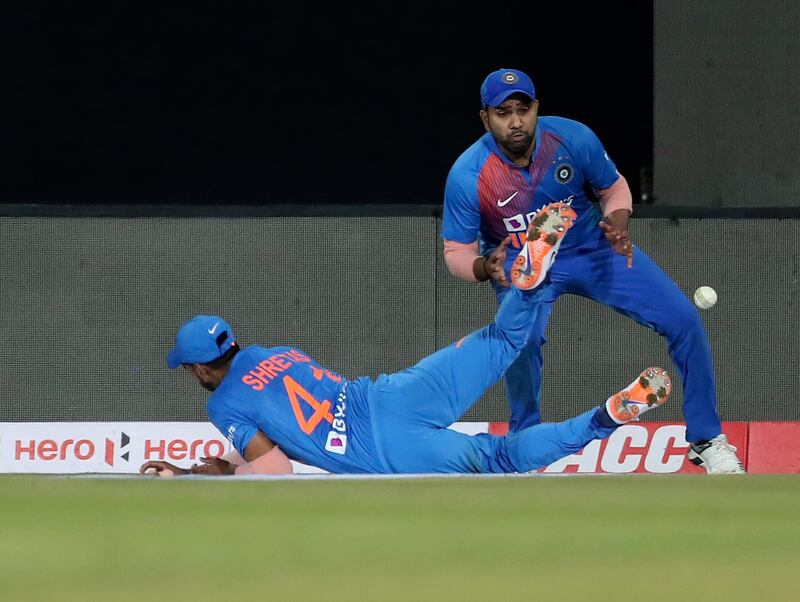 India's Rohit Sharma watches as teammate Shreyas Iyer, left, drops a catch off Nicholas Pooran. AP
