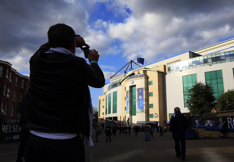 A football fan takes a picture of the outside of Stamford Bridge ahead of Tuesday night's Champions League match between Chelsea and Paris Saint-Germain. Adrian Dennis / AFP / April 8, 2014