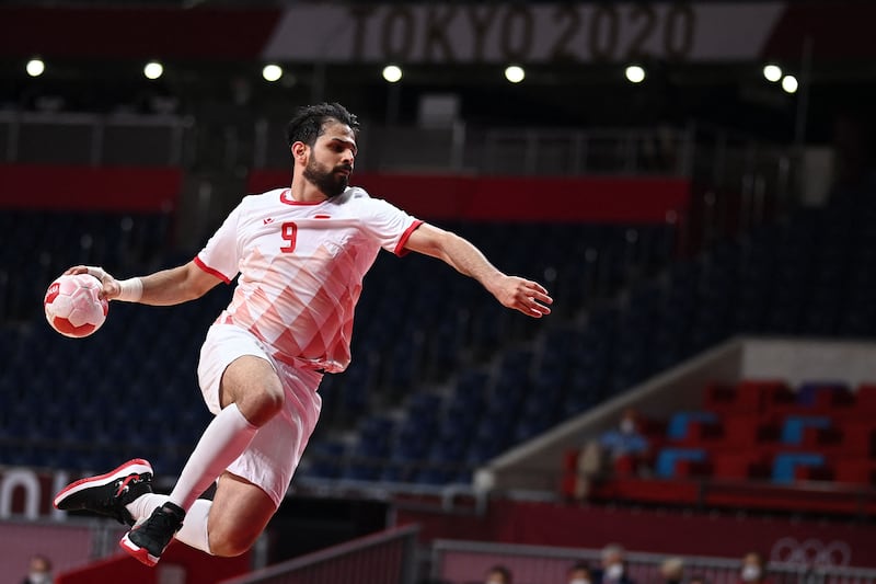 Bahrain's Hasan Al Samahiji jumps to shoot during the men's preliminary round handball match between Sweden and Bahrain. Sweden survived a scare to win 32-31.