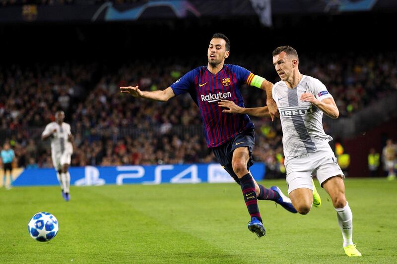 Barcelona midfielder Sergio Busquets, left,  tussles with Inter Milan's winger Ivan Perisic at Camp Nou. Barcelona won the Uefa Champions League Group B match on Wednesday 2-0. EPA