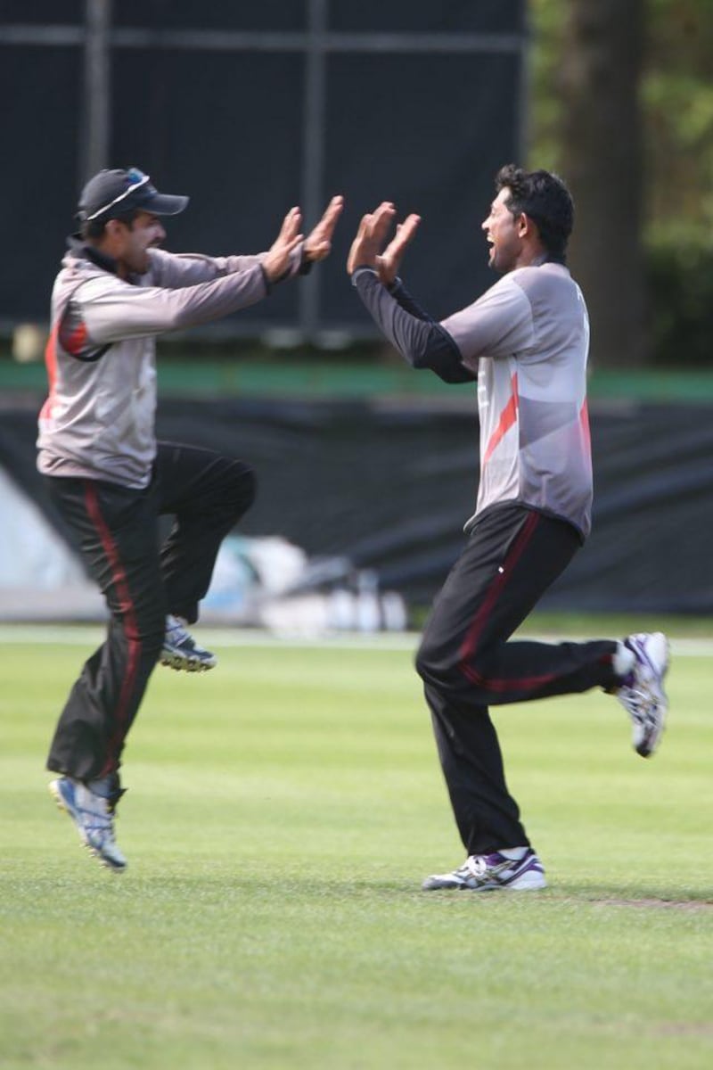 UAE cricket players Khurram Khan and (left) and Amjad Jared celebrates after beating Namibia during the ICC Cricket World Cup Qualifier against Namibia at the Rangiora Oval, Christchurch. 30th January 2014. Image courtesy ICC