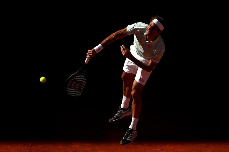 Federer serves out of the shadows. Getty