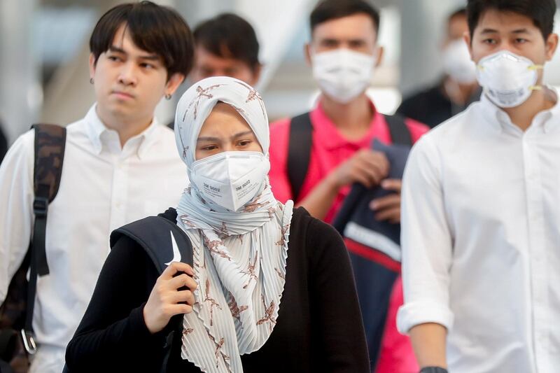 People wear face masks as heavy air pollution continues to affect Bangkok on January 30, 2019.  EPA