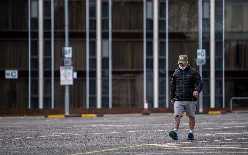 Hotel guests exercise in the car park of the Radisson Blu hotel as they continue their quarantine.