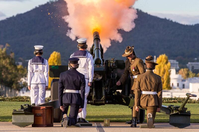 Members of Australia's Federation Guard fire a M2A2 howitzer during a 41-gun salute held at Parliament House in Canberra to honour Britain's Prince Philip, who died on Friday. AFP