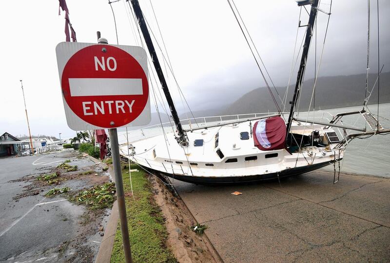 A boat smashed against the bank at Shute Harbour, Airlie Beach. Dan Peled/ AAP image via Reuters