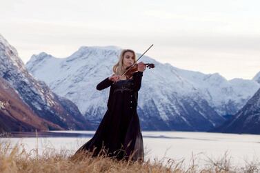 The fjord's of Trondheim provide a breathtaking backdrop for Norwegian violinist Ingrid Maeland. Courtesy Expo 2020         Download     100%    