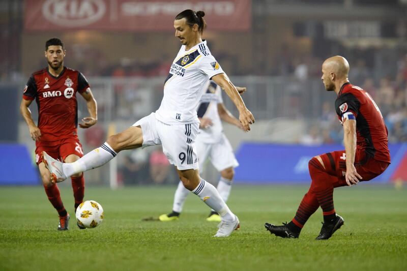 Los Angeles Galaxy forward Zlatan Ibrahimovic (9) controls the ball against Toronto FC midfielder Michael Bradley (4) during the first half of an MLS soccer game, Saturday, Sept. 15, 2018 in Toronto. (Cole Burston/Canadian Press via AP)