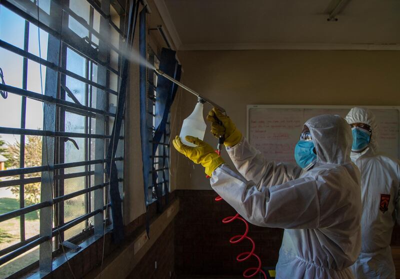 A disinfection team sprays inside a classroom at Ivory Park Secondary School east of Johannesburg, South Africa. AP Photo