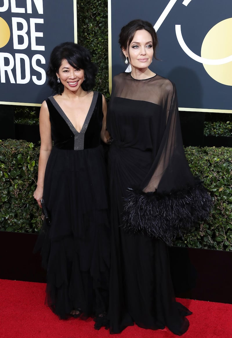 epa06423957 Angelina Jolie (R) and Loung Ung arrive for the 75th annual Golden Globe Awards ceremony at the Beverly Hilton Hotel in Beverly Hills, California, USA, 07 January 2018.  EPA-EFE/MIKE NELSON