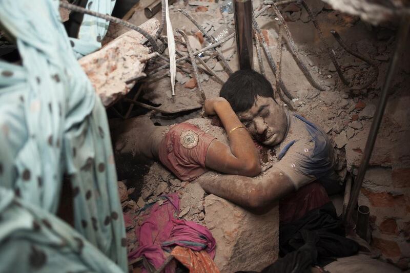 Embraced in death. The bodies of these garment factory workers were found after a building collapsed in Dhaka, Bangladesh. Taslima Akhter 





