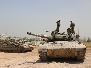 Israeli soldiers with their tanks gather at an undisclosed location near the border fence with the Gaza Strip, in southern Israel on Monday.  EPA
