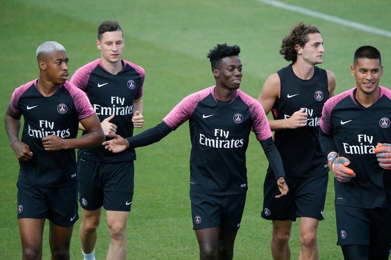 Timothy Weah, centre, runs with teammates during a training session. AP Photo