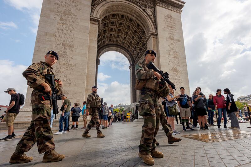 French soldiers patrol near the Arc de Triomphe after a night of clashes in Paris. EPA