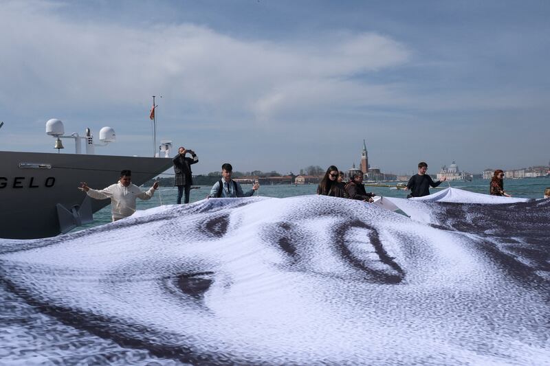 A giant photograph of a young refugee is unveiled as part of an art installation by French contemporary artist JR to show solidarity with Ukraine, in Venice, Italy. Reuters