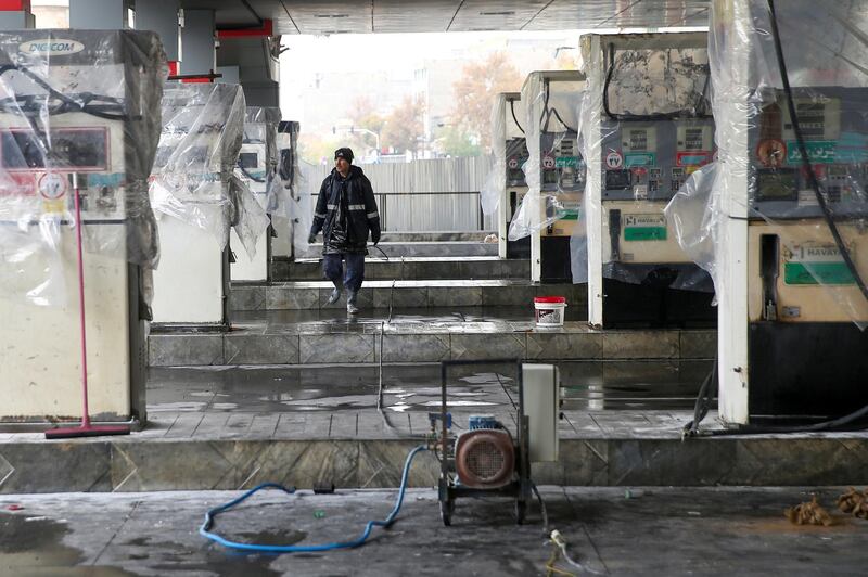 FILE PHOTO: A man walks near the remains of gas pump stands, during protests against increased fuel prices, in Tehran, Iran November 20, 2019. Picture taken November 20, 2019. Nazanin Tabatabaee/WANA (West Asia News Agency) via REUTERS ATTENTION EDITORS - THIS IMAGE HAS BEEN SUPPLIED BY A THIRD PARTY/File Photo