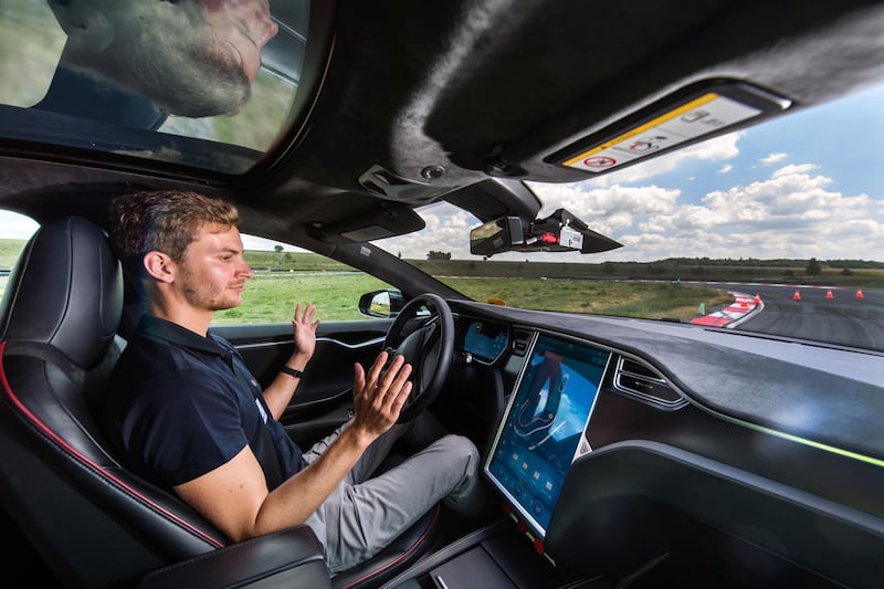 A test driver removes his hands from the steering wheel of a Tesla Motors Inc. Model S electric automobile fitted with self driving technology, developed by Robert Bosch GmbH, during the Bosch mobility experience in Boxberg, Germany, on Tuesday, July 4, 2017. Auto supplier Bosch will build a 1 billion-euro ($1.1 billion) semiconductor plant, the biggest single investment in its history, as the maker of brakes and engines prepares for a surge in demand for components used in self-driving vehicles. Photographer: Andreas Arnold/Bloomberg