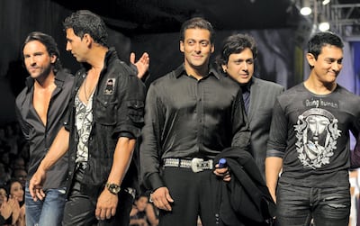 (FromL) Indian Bollywood actors Saif Ali Khan, Akshay Kumar, Salman Khan, Govinda and Aamir Khan walk on the catwalk for Indian Bollywood actor Salman Khans foundation's "Being Human" on the second day of the HDIL India Couture Week in Mumbai on October 13, 2009. India is hosting its second ever haute couture week showcasing over five days.   AFP PHOTO/ SAJJAD HUSSAIN (Photo by SAJJAD HUSSAIN / AFP)