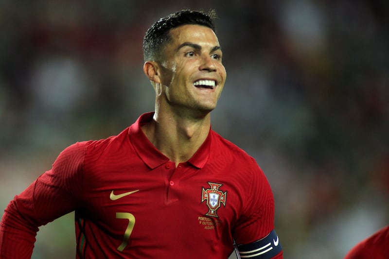 Portugal's Cristiano Ronaldo smiles after scoring the opening goal during the international friendly match against Qatar at the Algarve stadium outside Faro, Portugal. AP