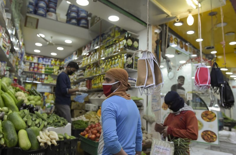 A grocery store displays protective masks for sale amid the Covid-19 pandemic in the old marketplace of the Bahraini capital Manama. AFP