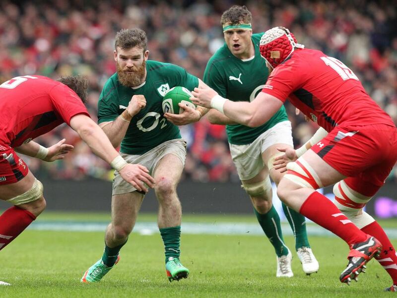 Ireland centre Gordon D'Arcy, second from left, is tackled by Wales' Jake Ball during the Six Nations international rugby union match at the Aviva Stadium in Dublin on Saturday. PETER MUHLY / AFP

