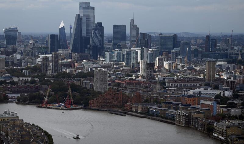 The skyline, including the office buildings of the City of London, is seen beyond the River Thames in London, England on September 02, 2020. / AFP / DANIEL LEAL-OLIVAS
