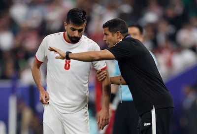 Jordan coach Hussein Ammouta talks to Noor Al Rawabdeh during the match. Reuters