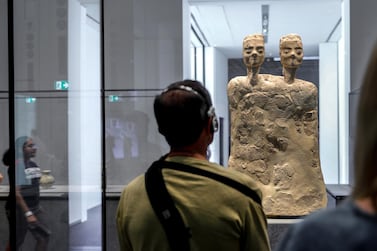 'The Pulse of Time' highlights pieces from Louvre Abu Dhabi's collection and works on loan from other institutions, such as a 6,500 BC statue from Jordan's Ain Ghazal. Victor Besa / The National
