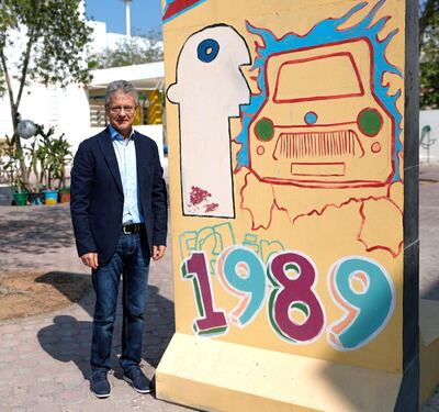 Abu Dhabi, United Arab Emirates, November 7, 2019.  
Description:STORY BRIEF: Story about Germans who remember the fall of the Berlin wall.
--Frank Michaelis posses in front of a Berlin wall artwork at the parking lot of the German International School, Abu Dhabi.
Victor Besa/The National
Section:  NA
Reporter:  John Dennehy