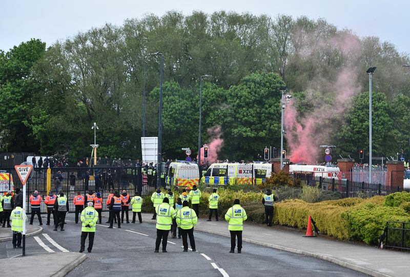 Police and stewards guard the back entrance at Old Trafford prior to the Premier League match between Manchester United and Liverpool. Getty