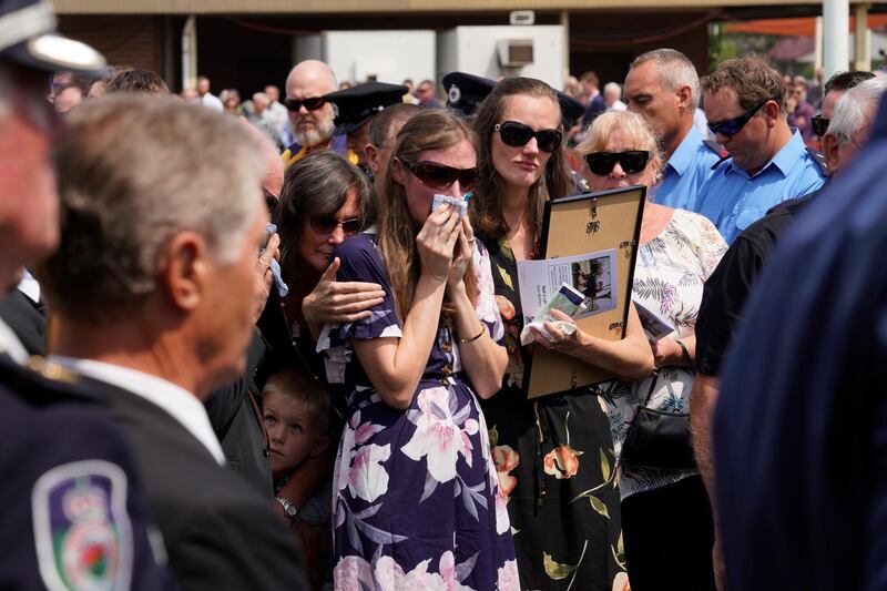 Sams widow, Megan wipes away tears as she watches the casket being loaded into the hearse during the funeral of NSW RFS volunteer firefighter Samuel McPaul at Holbrook Sports Stadium  in Albury, NSW, Australia. McPaul died  while he was fighting the Green Valley blaze on December 30. Getty Images