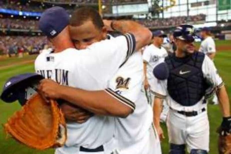 Starting pitcher CC Sabathia Milwaukee Brewers hugs manager Dale Sveum as they celebrate clinching the National League Wild Card after the game against the Chicago Cubs at Miller Park on September 28, 2008 in Milwaukee, Wisconsin. The Brewers defeated the Cubs 3-1.  AFP PHOTO/Darren Hauck/Getty Images
== FOR NEWSPAPERS, INTERNET, TELCOS & TELEVISION USE ONLY == *** Local Caption ***  369097-01-08.jpg