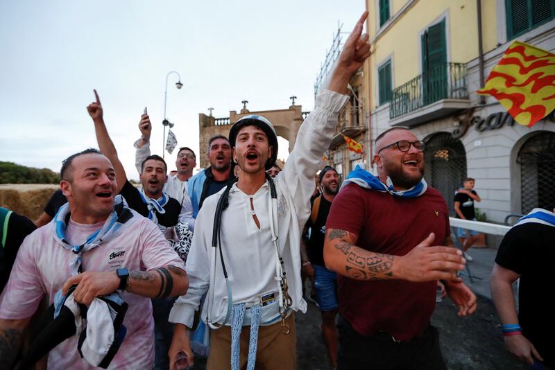 Supporters of the Fontana Grande parish in Ronciglione celebrate after their horse wins the event.