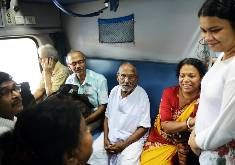 Indian monk Swami Sivananda, centre, who claims to be 120 years old, sits with followers on board a train from Howrah station on his way to Varanasi from Kolkata. All photos by Dibyangshu Sarkar / AFP