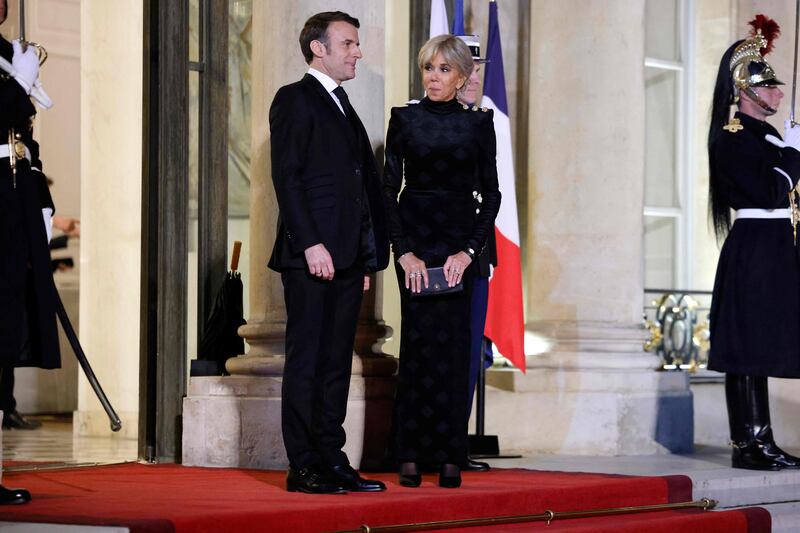 Mr Macron and his wife Brigitte wait for the arrival of Sheikh Tamim. AFP