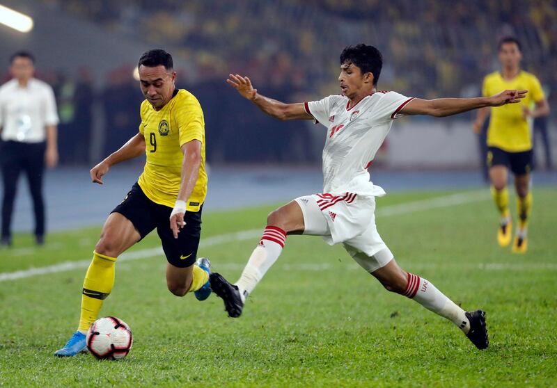 UAE's Mohammed Al Attas, right, challenges Norshahrul Idlan of Malaysia. AP